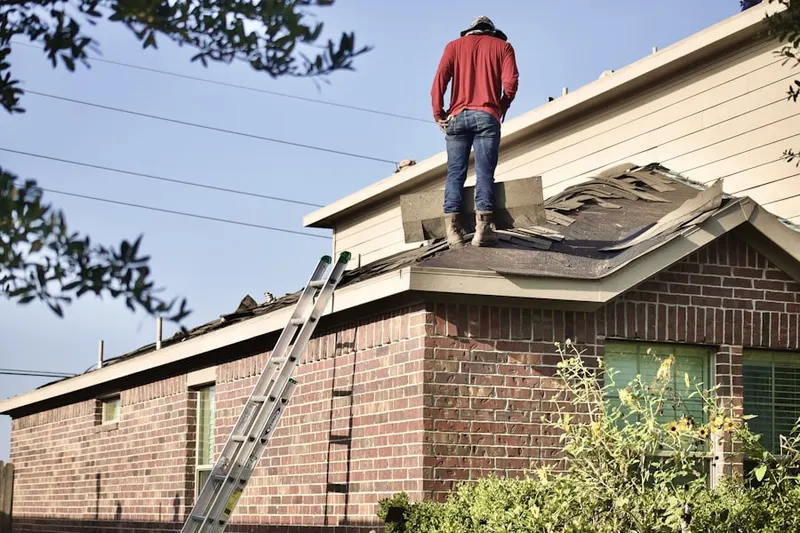 Professional roofer working on a residential roof in Oak Springs